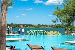 Outdoor amenities at the Saint Leo U. Wellness Center include an infinity-edged recreational pool, resort style seating, a fire pit, and a barbecue area — all with a beautiful view of Lake Jovita.