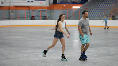 Roller skating on an ice rink’s concrete slab.