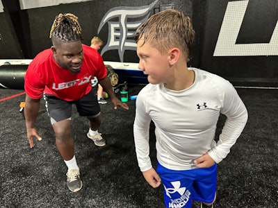 Former Atlanta Falcons linebacker Sean Weatherspoon trains with a young athlete at Legacy Sports Complex in Suwanee, Ga.