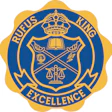 Official institutional emblem with crown, scales of justice, and books in blue and gold