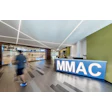 MMAC fitness center lobby with modern design, reception desk, and view into gymnasium