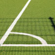 Soccer or football field corner with white boundary line on green artificial turf