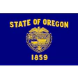 Oregon state flag with blue background and yellow seal featuring pioneer scene