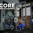 Women performing barbell squats in blue workout attire at Core Health & Fitness gym