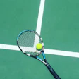 Tennis racket holding yellow ball on green court with white boundary line
