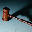 Wooden gavel on a textured blue-gray surface