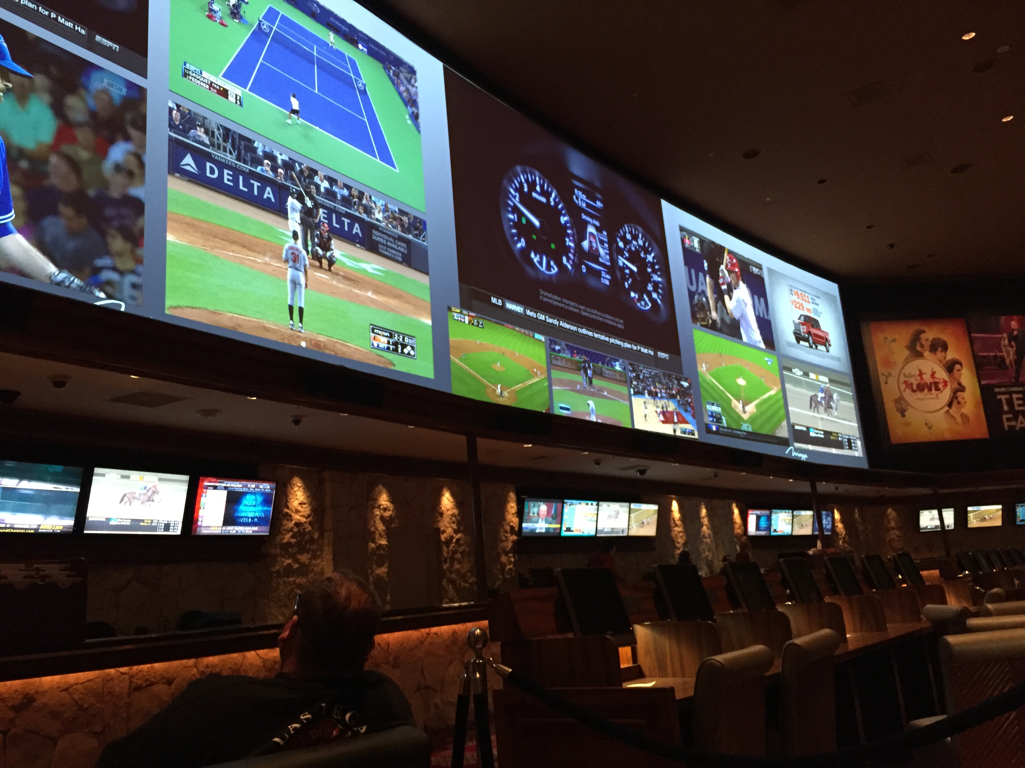 Sports bar with multiple screens showing live baseball, tennis, and sports broadcasts