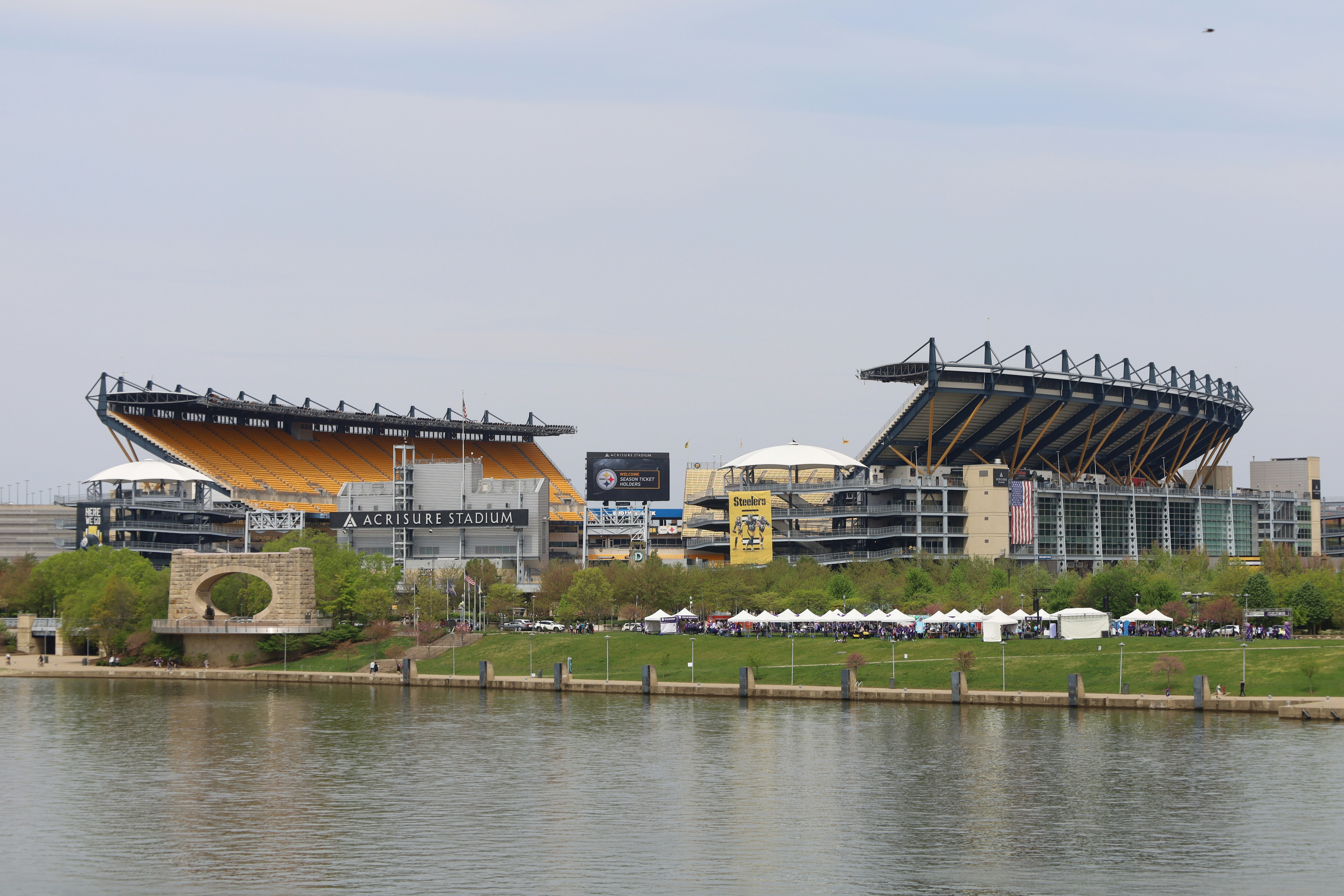 Heinz Field stadium in Pittsburgh with white tents and river in foreground