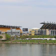 Heinz Field stadium in Pittsburgh with white tents and river in foreground