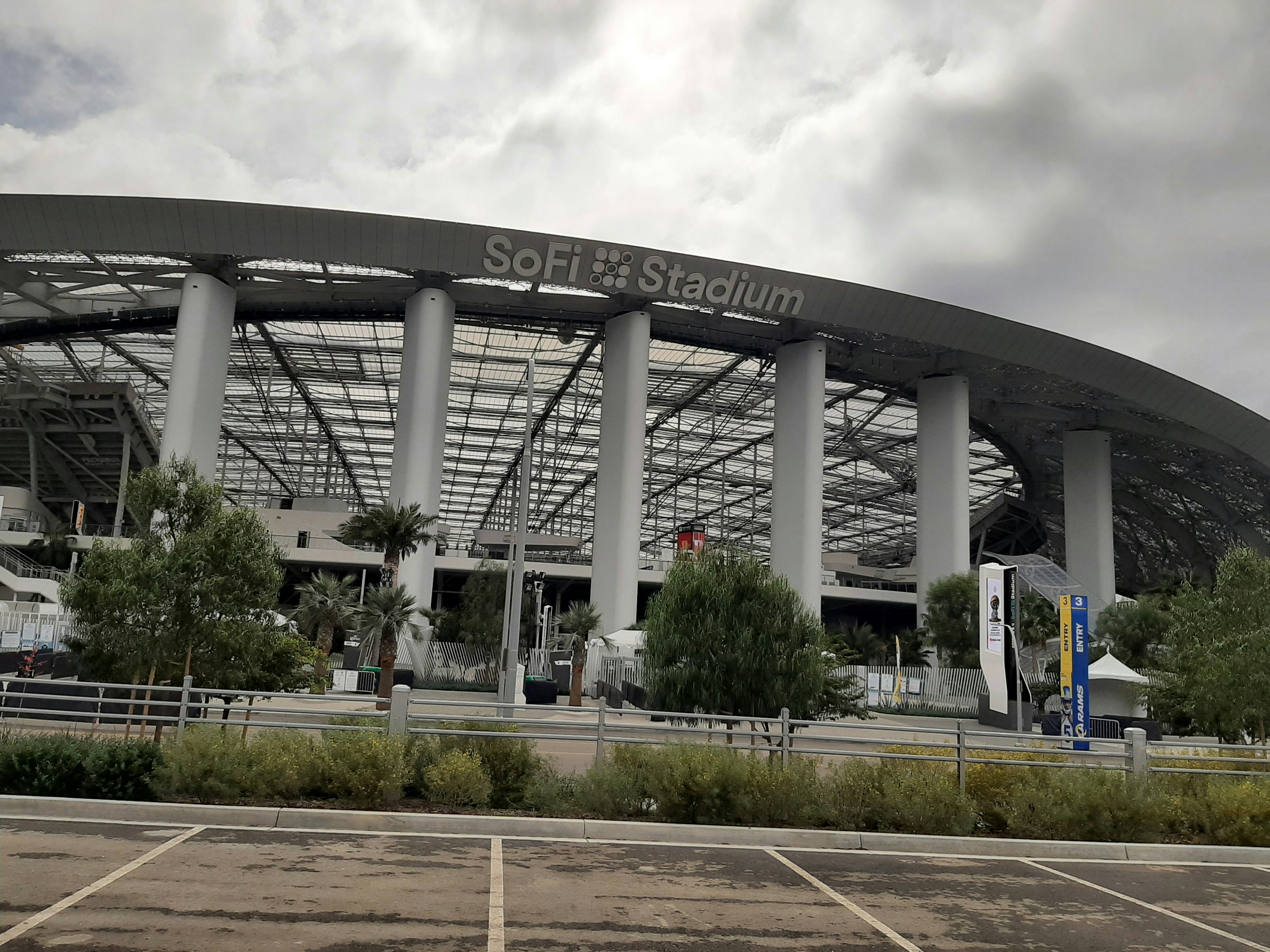 SoFi Stadium exterior with large white columns and modern architectural design