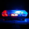 Police emergency light bar glowing red and blue at night