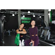 Two fitness enthusiasts at Fitness World gym with exercise equipment