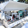 Commercial pool or water treatment equipment with white enclosure and complex piping system