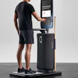 Person using interactive fitness measurement device with digital screen