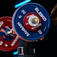 Blue and red Eleiko Olympic weightlifting plates on a barbell