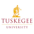 Tuskegee University official logo with golden statue and red text