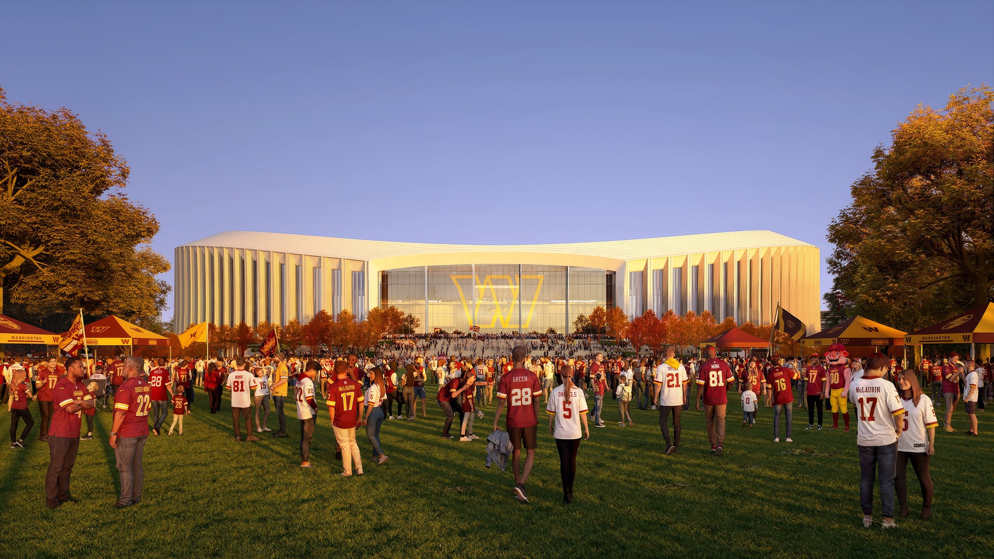 Large crowd wearing sports jerseys gathered on grass in front of modern stadium building during golden hour