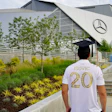 Person wearing Isovic number 20 jersey standing in front of modern Mercedes-Benz stadium with landscaped grounds