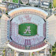 Aerial view of Bryant-Denny Stadium with crimson seating, green field, and Alabama 'A' logo