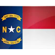 North Carolina state seal featuring white star between N and C letters with historical date ribbons on navy background, adjacent to state flag