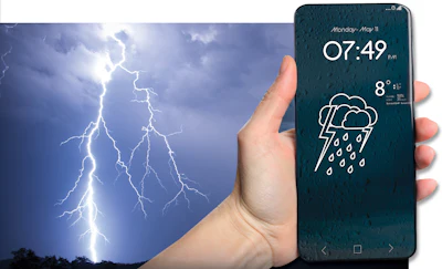 Smartphone displaying rainy weather forecast with 8°C temperature held against dramatic lightning storm background