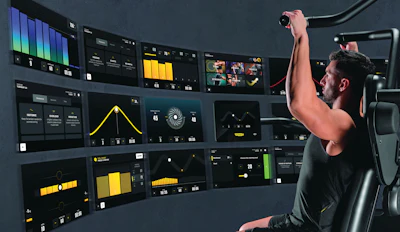 Video production control room with operator adjusting equipment while monitoring multiple displays showing editing and color grading software interfaces.