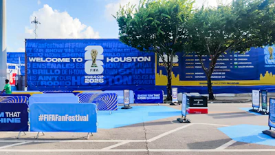 FIFA World Cup 2026 Fan Festival welcome sign in Houston with blue branded barriers and event setup