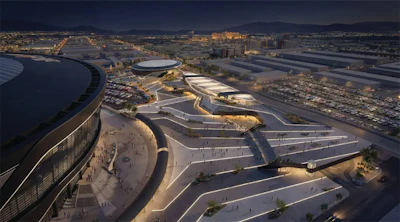 Aerial view of modern architectural complex with curved buildings and illuminated pathways at dusk in urban landscape