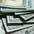 Stack of U.S. hundred dollar bills fanned out showing currency details and security features