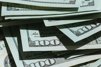 Stack of U.S. hundred dollar bills fanned out showing currency details and security features
