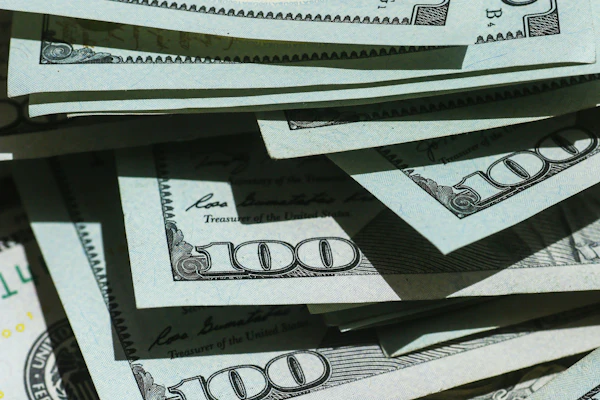 Stack of U.S. hundred dollar bills fanned out showing currency details and security features