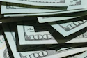 Stack of U.S. hundred dollar bills fanned out showing currency details and security features