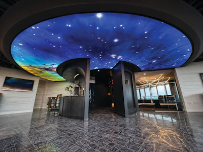 Modern lobby with illuminated starry night sky ceiling, polished dark floor, and contemporary architectural design elements