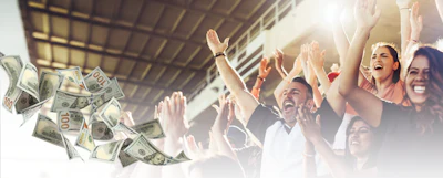 Excited group of people celebrating with arms raised as money falls around them in a bright, successful moment