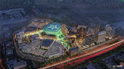 Aerial rendering of illuminated sports stadium complex with green roof logo, surrounded by urban buildings and highway at dusk