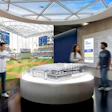 Modern stadium visitor center with curved architecture, baseball field views, and interactive displays featuring Tampa Bay Rays branding