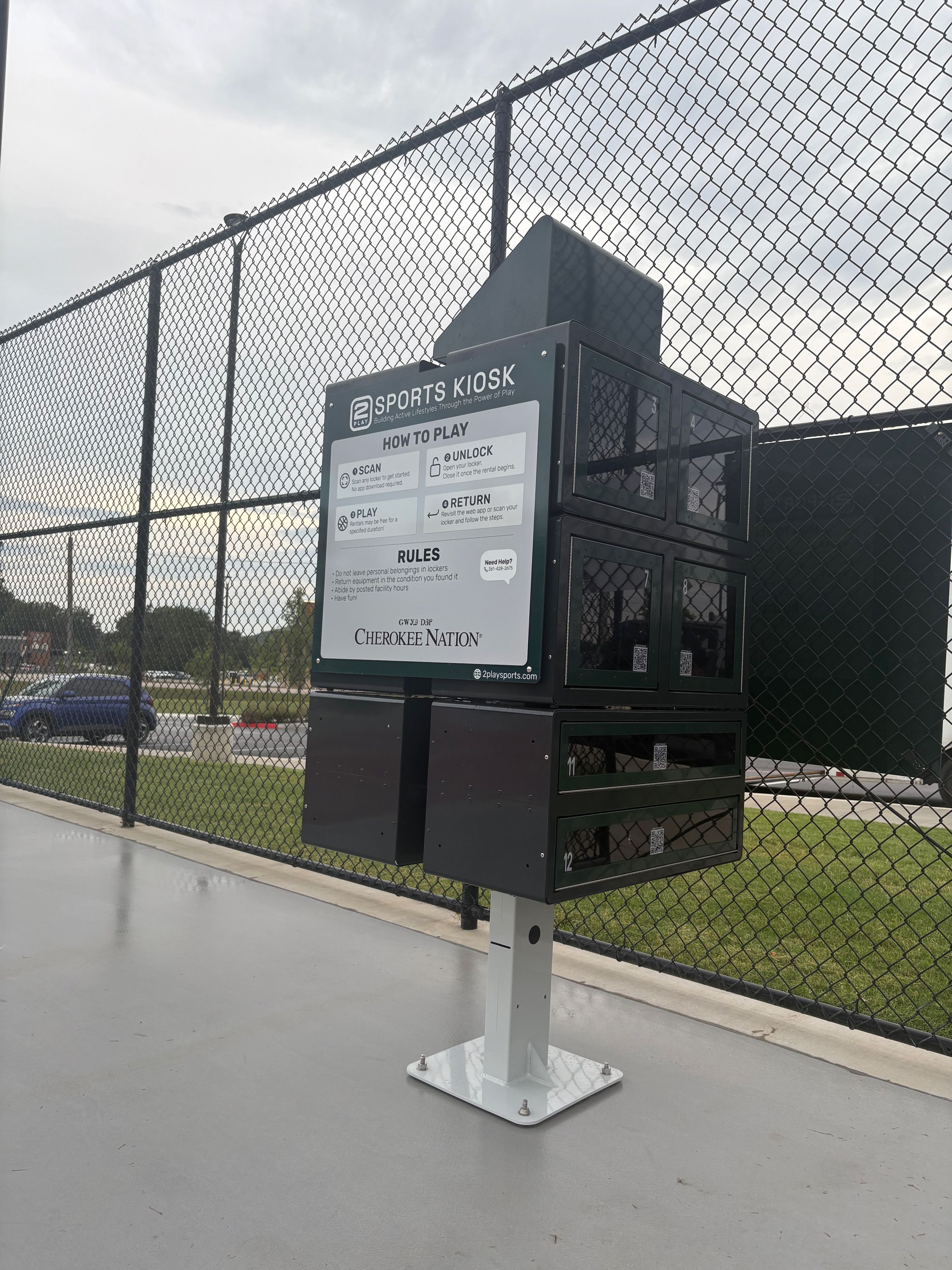 Sports Kiosk equipment station at baseball field with instructional signage and Cherokee Nation branding