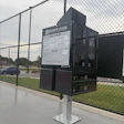 Sports Kiosk equipment station at baseball field with instructional signage and Cherokee Nation branding