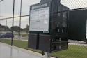Sports Kiosk equipment station at baseball field with instructional signage and Cherokee Nation branding