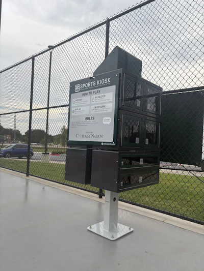 Sports Kiosk equipment station at baseball field with instructional signage and Cherokee Nation branding