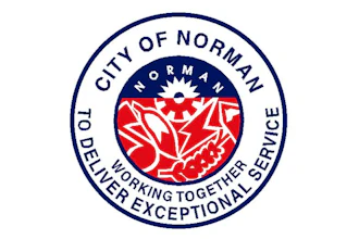 City of Norman official seal featuring red floral design with 'Working Together Delivering Exceptional Service' motto