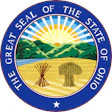 Great Seal of the State of Ohio featuring a circular blue border with gold text, central landscape with rising sun, mountains, and wheat sheaf