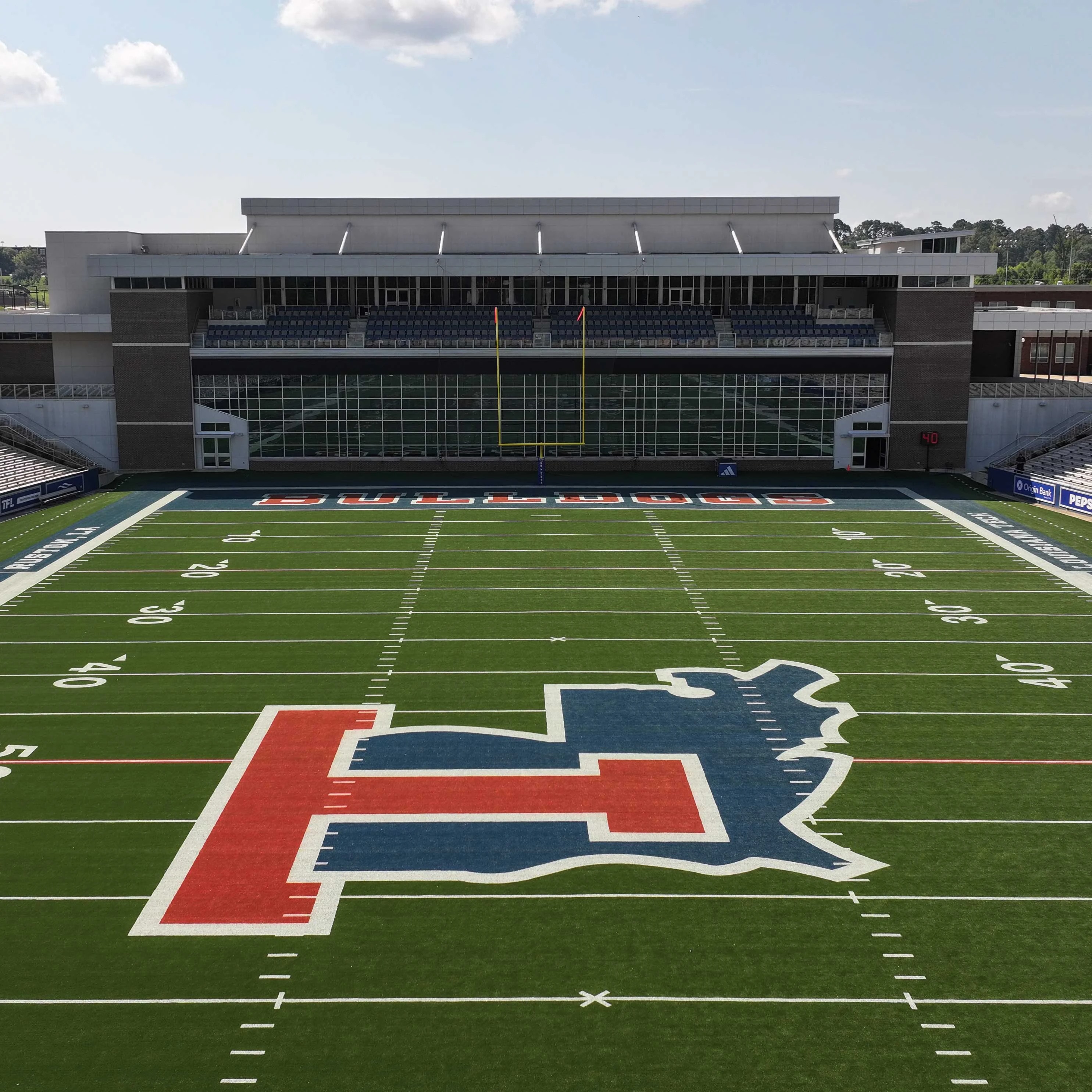 University of Illinois Illini logo on football field with stadium seating in background