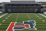 University of Illinois Illini logo on football field with stadium seating in background