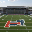 University of Illinois Illini logo on football field with stadium seating in background