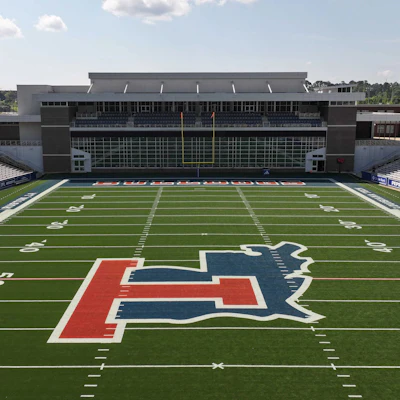 University of Illinois Illini logo on football field with stadium seating in background