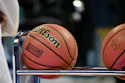 Wilson basketballs with March Madness branding displayed on a rack