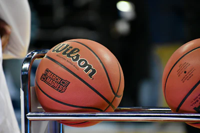 Wilson basketballs with March Madness branding displayed on a rack
