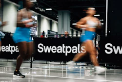 Athletes training indoors at Sweatpals fitness facility with motion blur effect