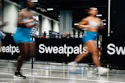 Athletes training indoors at Sweatpals fitness facility with motion blur effect